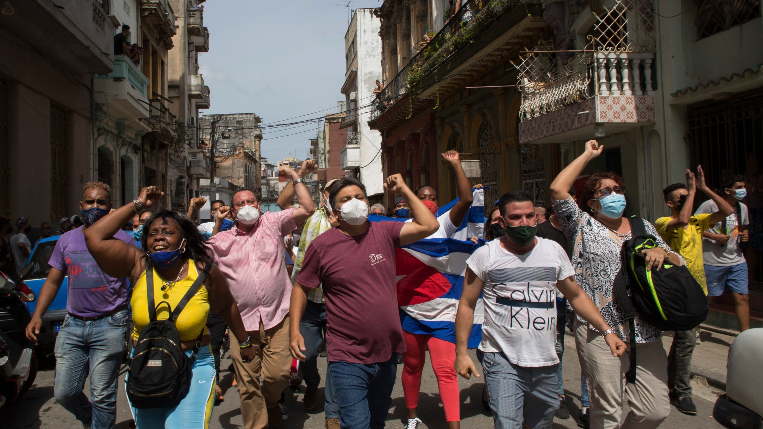 Government supporters shout slogans as anti-government protesters march in Havana, Cuba, Sunday, July 11, 2021. Hundreds of demonstrators went out to the streets in several cities in Cuba to protest against ongoing food shortages and high prices of foodstuffs. (AP Photo/Ismael Francisco)