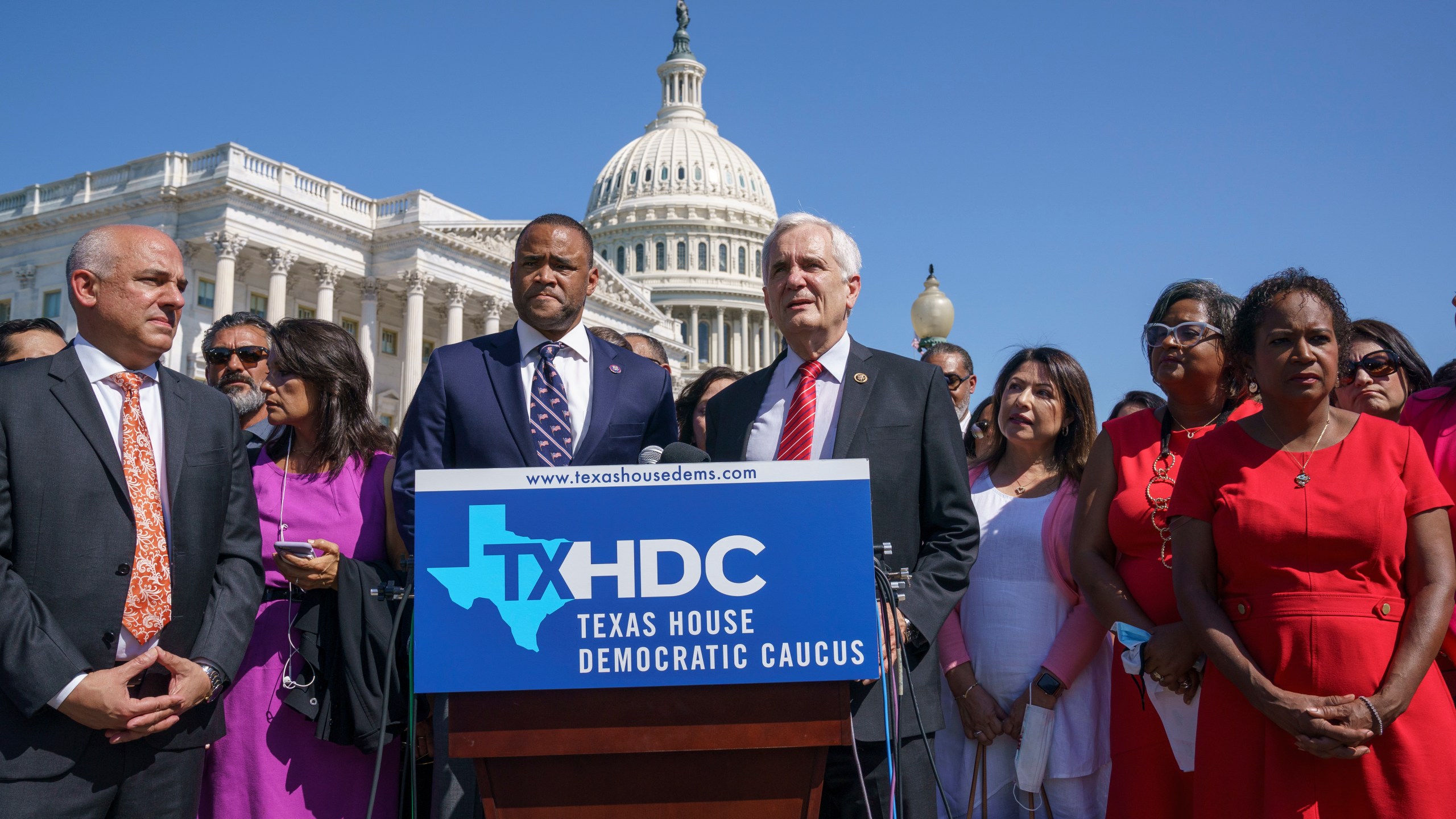 Rep. Marc Veasey, D-Texas, center left, and Rep. Lloyd Doggett, D-Texas, joined at left by Rep. Chris Turner, chairman of the Texas House Democratic Caucus, welcome Democratic members of the Texas legislature at a news conference at the Capitol in Washington, Tuesday, July 13, 2021. The lawmakers left Austin hoping to deprive the Texas Legislature of a quorum — the minimum number of representatives who have to be present for the body to operate, as they try to kill a Republican bill making it harder to vote in the Lone Star State. (AP Photo/J. Scott Applewhite)