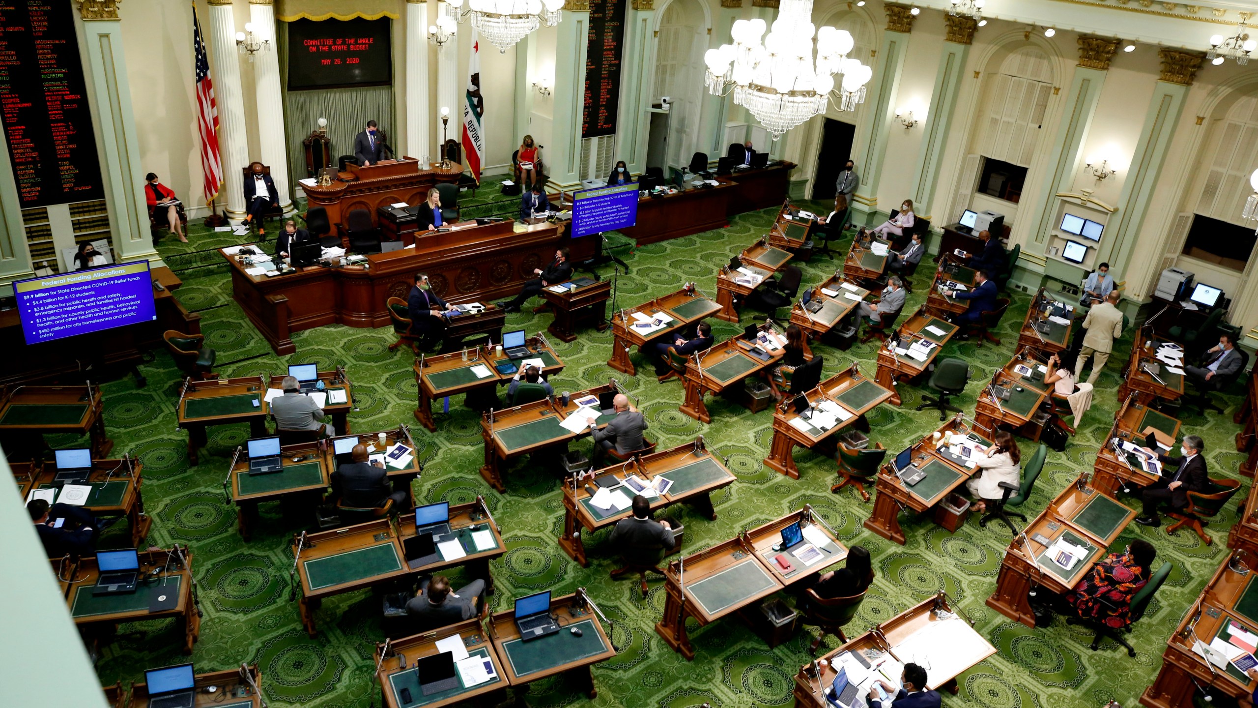 In this May 26, 2020, file photo, members of the state Assembly meet at the Capitol in Sacramento, Calif. On Thursday, July 15, 2021, California lawmakers are scheduled to vote on a bill that would fund guaranteed income programs across the state. Guaranteed income programs give money to people each month with no restrictions on how they can spend it. (AP Photo/Rich Pedroncelli, Pool, File)