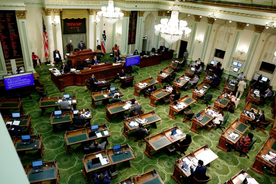 In this May 26, 2020, file photo, members of the state Assembly meet at the Capitol in Sacramento, Calif. On Thursday, July 15, 2021, California lawmakers are scheduled to vote on a bill that would fund guaranteed income programs across the state. Guaranteed income programs give money to people each month with no restrictions on how they can spend it. (AP Photo/Rich Pedroncelli, Pool, File)