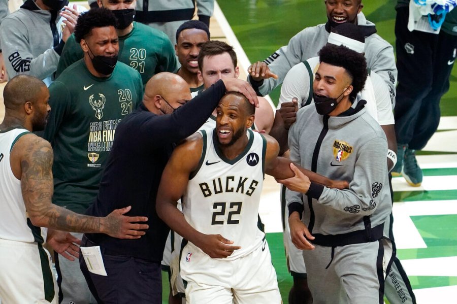 Milwaukee Bucks forward Khris Middleton (22) celebrates with teammates during the second half against the Phoenix Suns in Game 4 of basketball's NBA Finals in Milwaukee, Wednesday, July 14, 2021. (AP Photo/Paul Sancya)