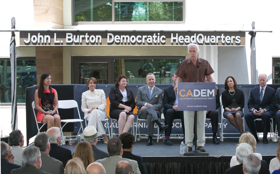 In this June 16, 2014, file photo. then-California Democratic Party Chairman John Burton speaks during the dedication of the John L. Burton California Democratic Party Headquarters in Sacramento, Calif., in Sacramento, Calif. Two California men have been charged with plotting to blow up the state Democratic Party's headquarters in Sacramento, a bombing they hoped would be the first in a series of politically-motivated attacks, federal prosecutors said Thursday, July 15, 2021. From left are then-House Minority Leader Nancy Pelosi, then-Assembly Speaker Toni Atkins, then-state Senate President Pro Term Darrell Steinberg. At right is then-Gov. Jerry Brown and second from right is then-California Attorney General Kamala Harris. (AP Photo/Rich Pedroncelli, File)