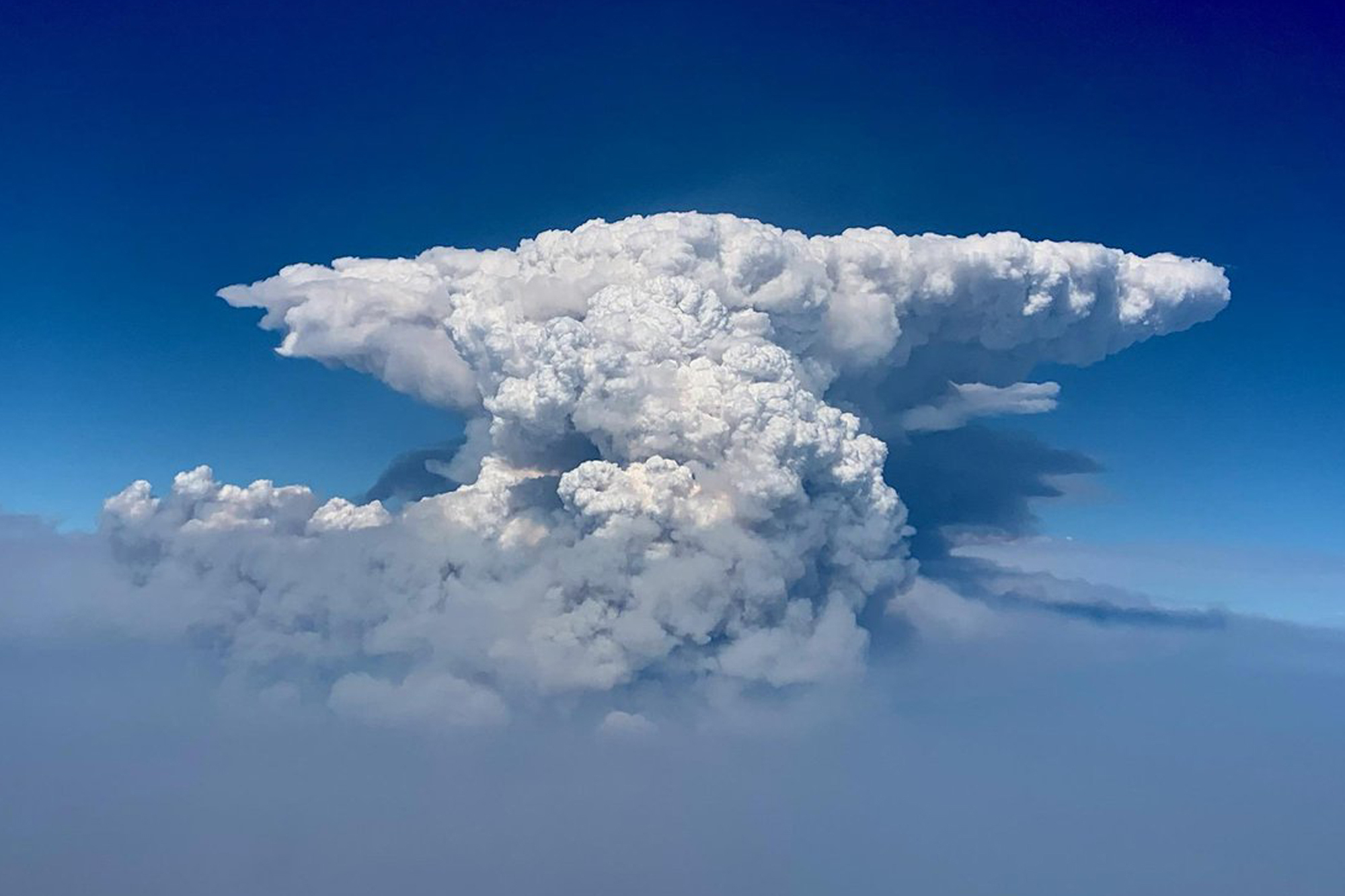 In this photo taken with a drone provided by the Bootleg Fire Incident Command, a pyrocumulus cloud, also known as a fire cloud, is seen over the Bootleg Fire in southern Oregon on July 14, 2021. (Bootleg Fire Incident Command via AP)