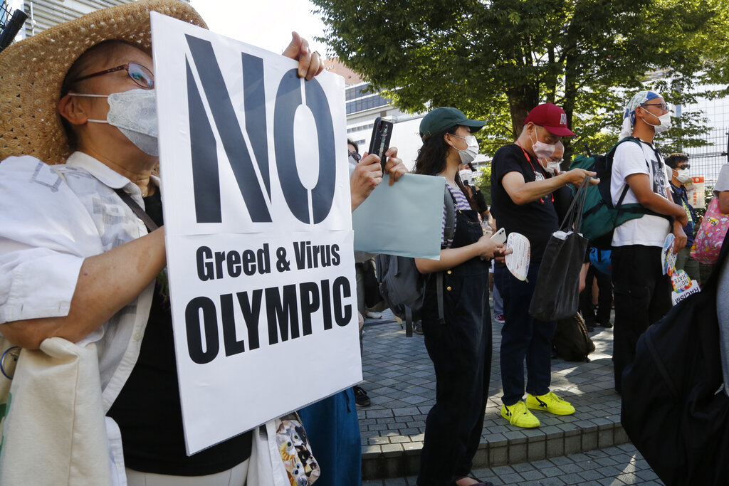 People gather for a rally in Tokyo's Shinjuku shopping district Sunday, July 18, 2021, to protest against the Olympics starting from July 23. (AP Photo/Yuri Kageyama)