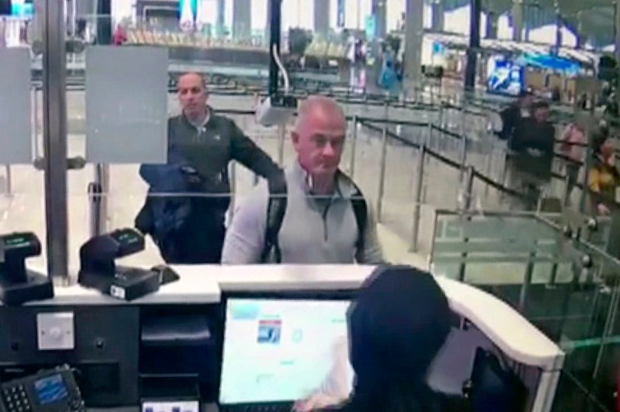 This Dec. 30, 2019, image from security camera video shows Michael L. Taylor, center, and George-Antoine Zayek at passport control at Istanbul Airport in Turkey. A Tokyo court handed down prison terms for the American father Michael Taylor and son Peter accused of helping Nissan’s former chairman, Carlos Ghosn, escape to Lebanon while awaiting trial in Japan.(DHA via AP, File)