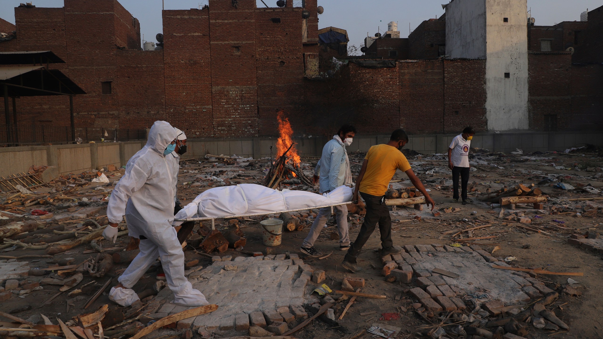 In this May 11, 2021, file photo, family members and volunteers carry the body of a COVID-19 victim for cremation in New Delhi, India. (Amit Sharma/Associated Press)