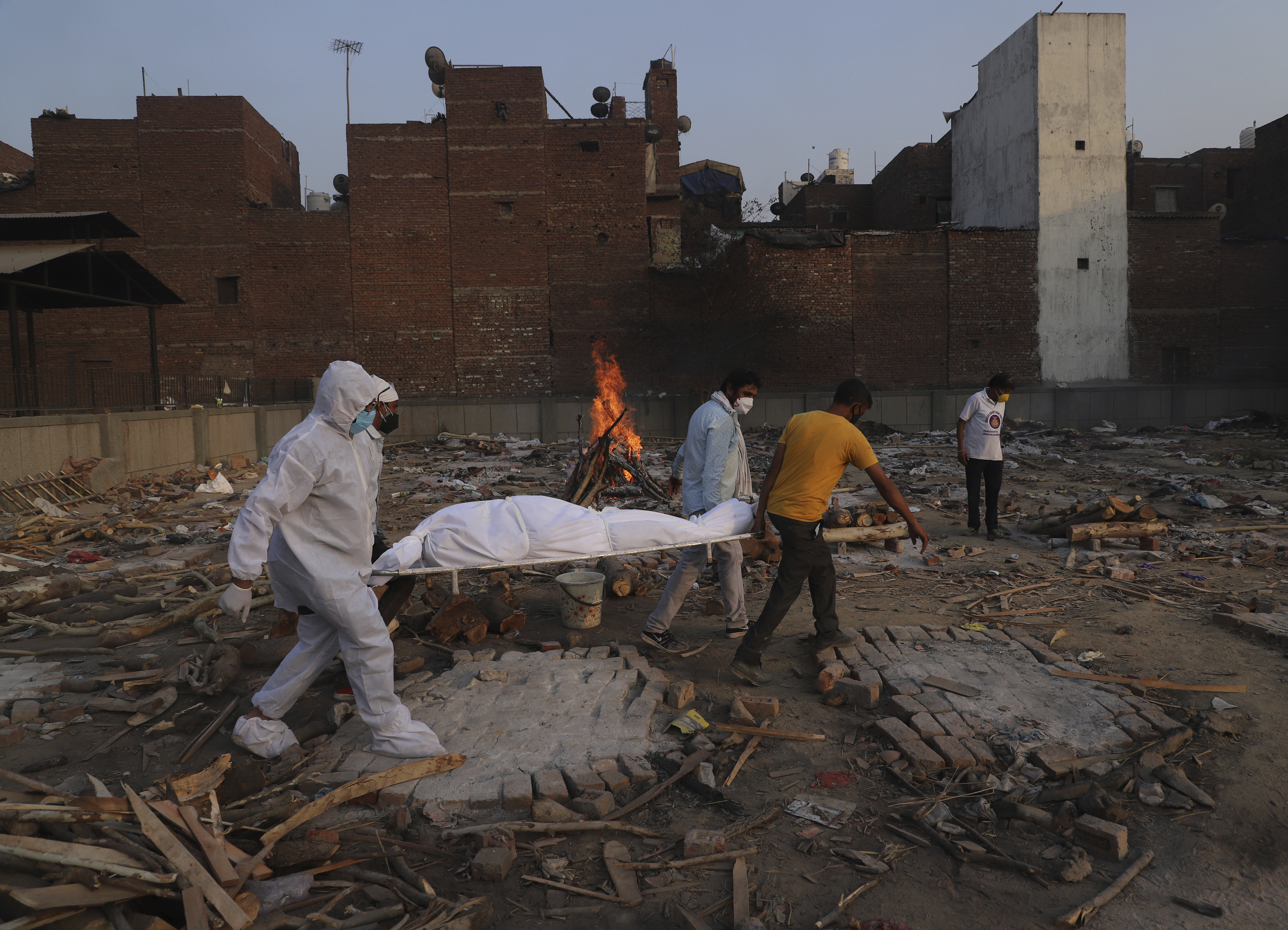 In this May 11, 2021, file photo, family members and volunteers carry the body of a COVID-19 victim for cremation in New Delhi, India. (Amit Sharma/Associated Press)