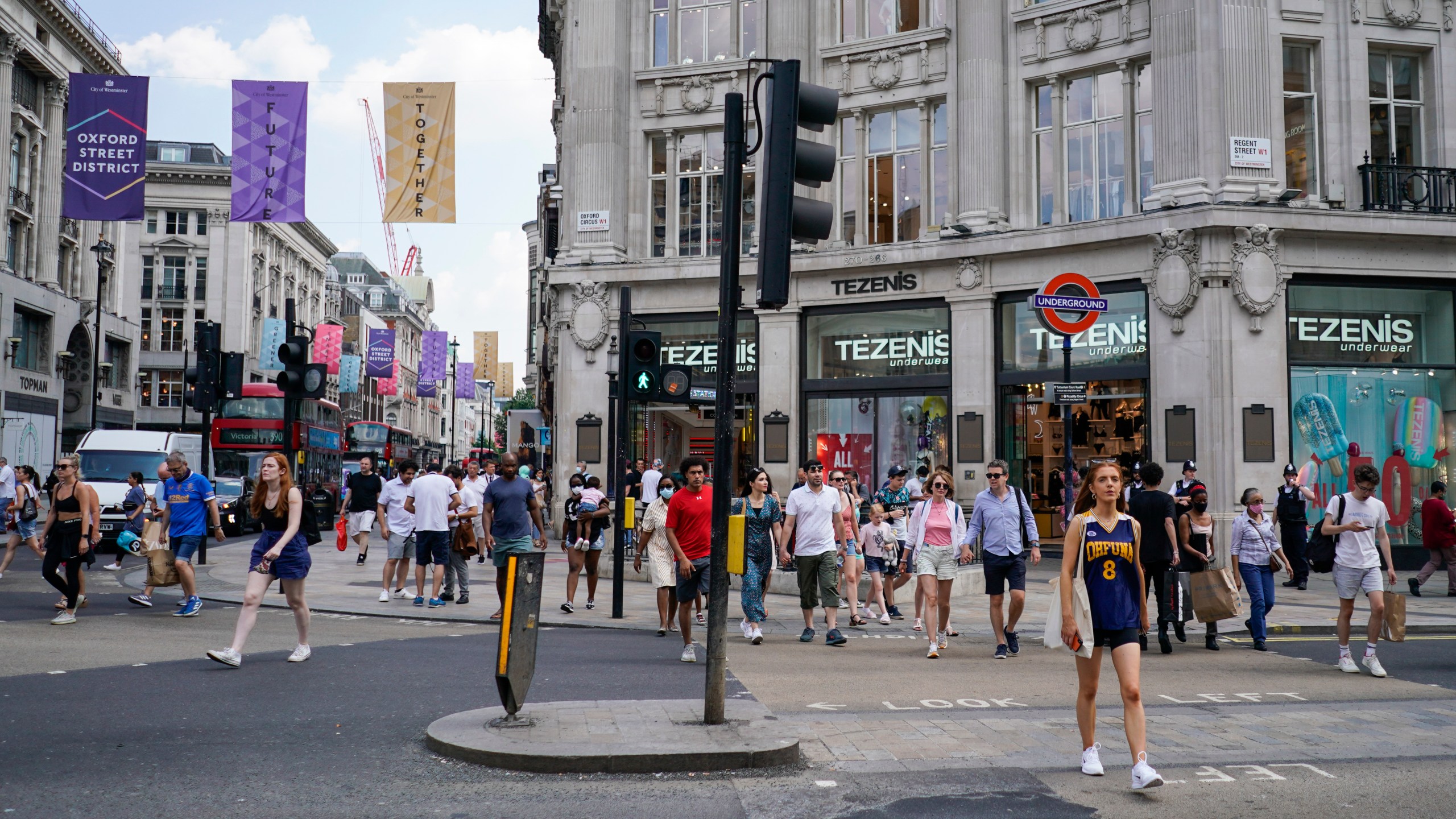 People walk in Oxford Circus, in London, Monday, July 19, 2021. (AP Photo/Alberto Pezzali)