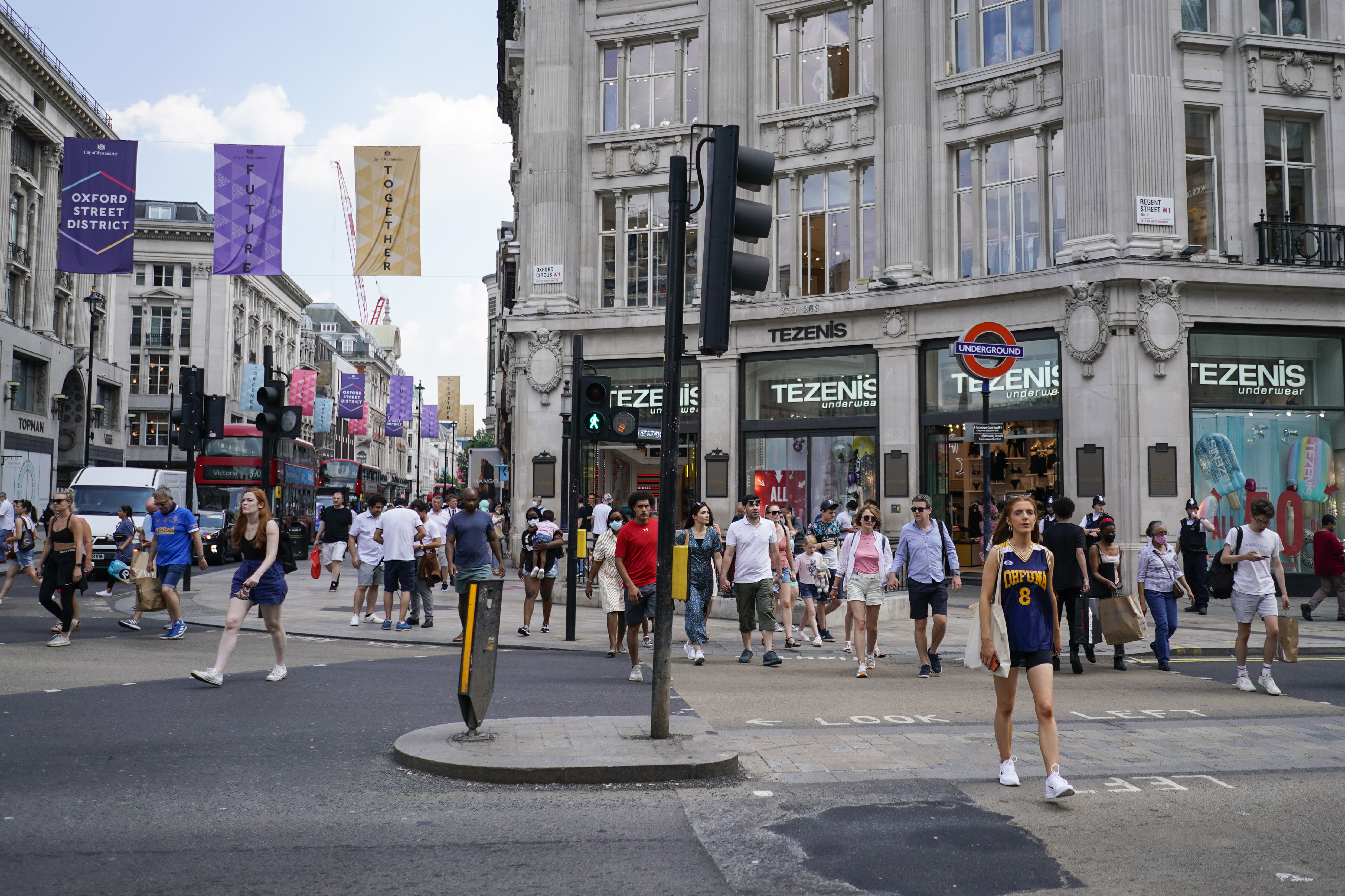 People walk in Oxford Circus, in London, Monday, July 19, 2021. (AP Photo/Alberto Pezzali)