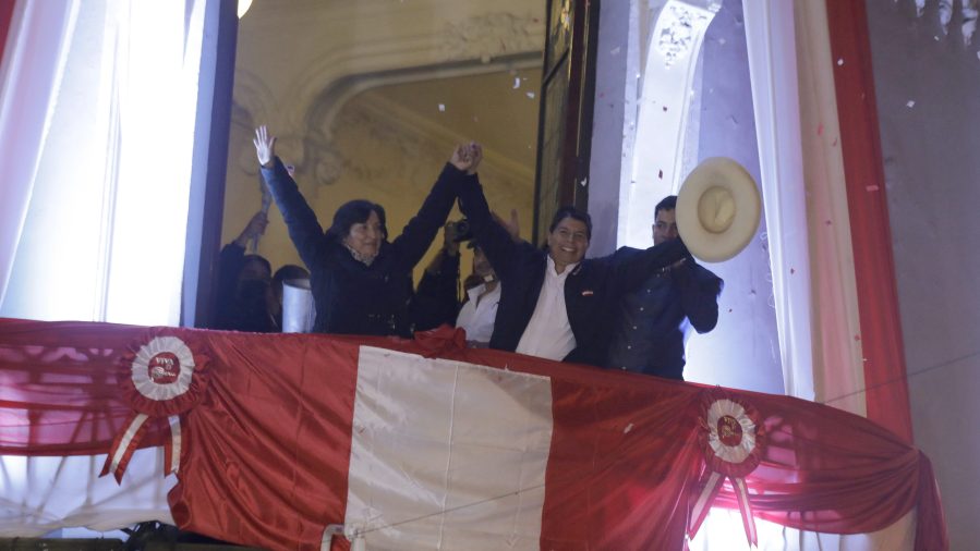 Pedro Castillo, center, celebrates with his running mate Dina Boluarte after being declared president-elect by election authorities at their campaign headquarters in Lima, Peru, on July 19, 2021. (Guadalupe Prado / Associated Press)