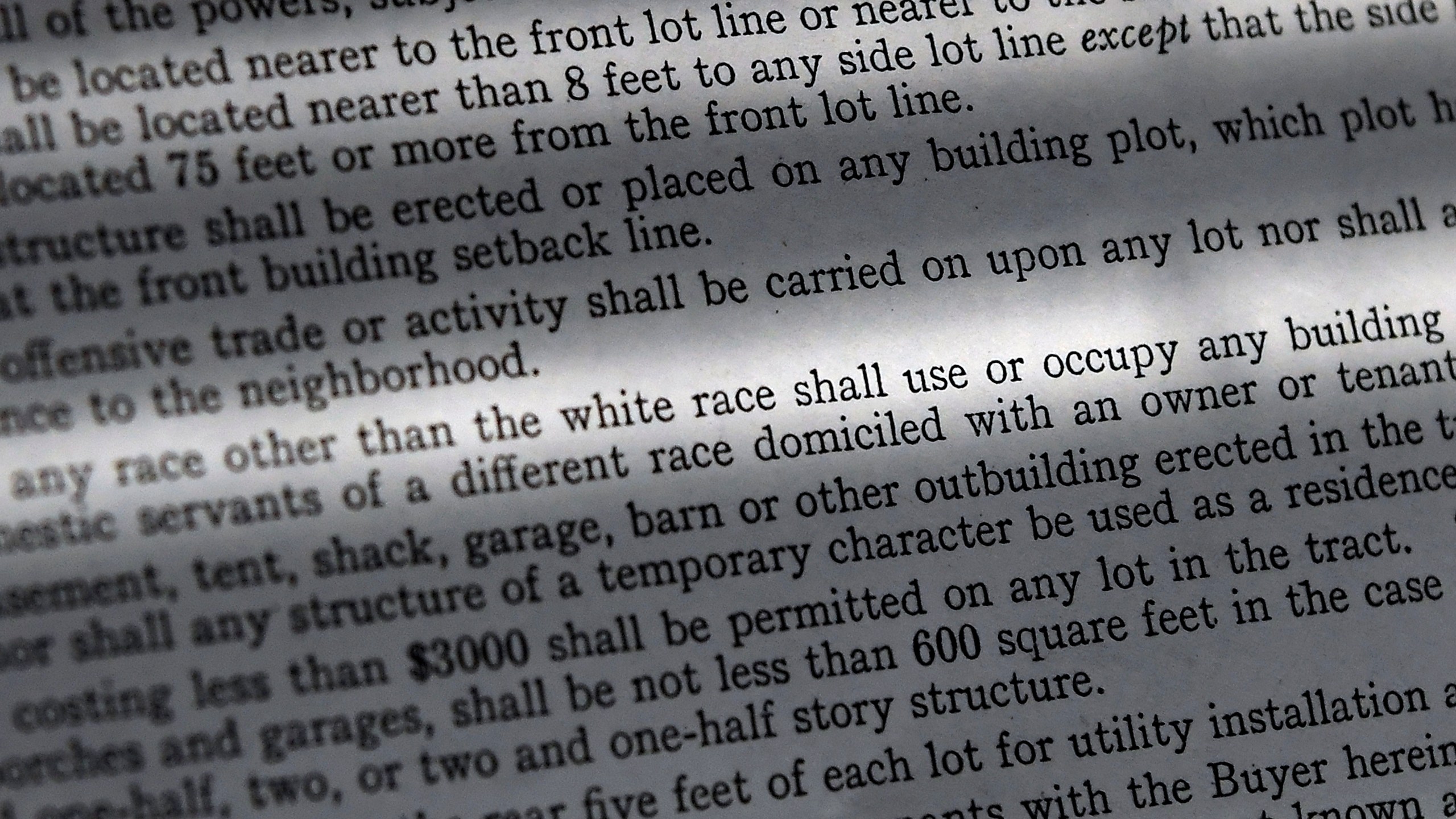 In this Saturday, July 17, 2021, photo, a copy of a covenant for property now owned by Fred Ware is seen in Manchester, Conn. Fred and Dave Ware recently found a whites-only covenant on his property dating back to 1942 when researching the title chain. The covenant described as letter "F" states that "No persons of any race other than the white race shall use or occupy any building or any lot, except that this covenant shall not prevent occupancy by domestic servants of a different race domiciled with an owner tenant." (AP Photo/Jessica Hill)