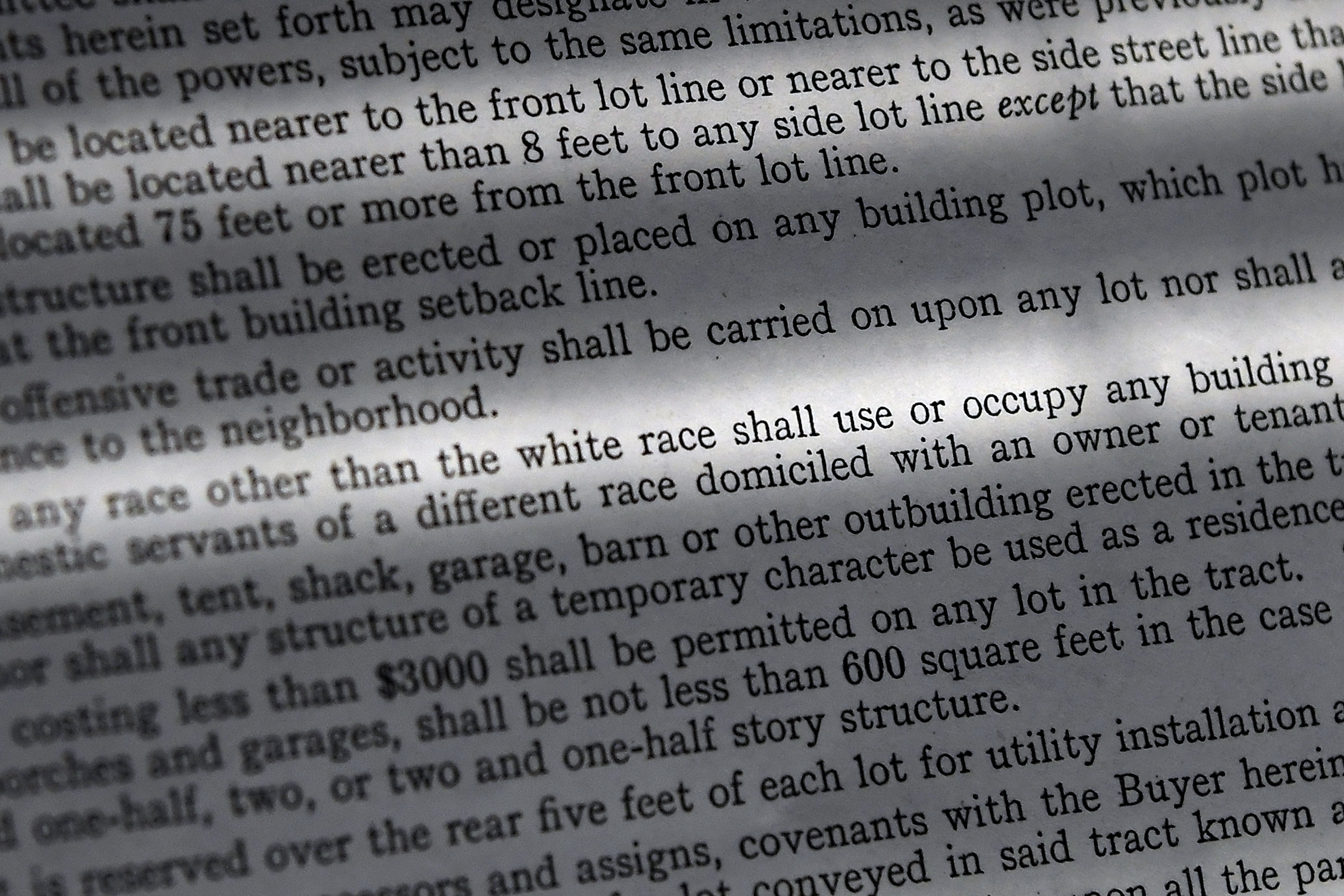 In this Saturday, July 17, 2021, photo, a copy of a covenant for property now owned by Fred Ware is seen in Manchester, Conn. Fred and Dave Ware recently found a whites-only covenant on his property dating back to 1942 when researching the title chain. The covenant described as letter "F" states that "No persons of any race other than the white race shall use or occupy any building or any lot, except that this covenant shall not prevent occupancy by domestic servants of a different race domiciled with an owner tenant." (AP Photo/Jessica Hill)