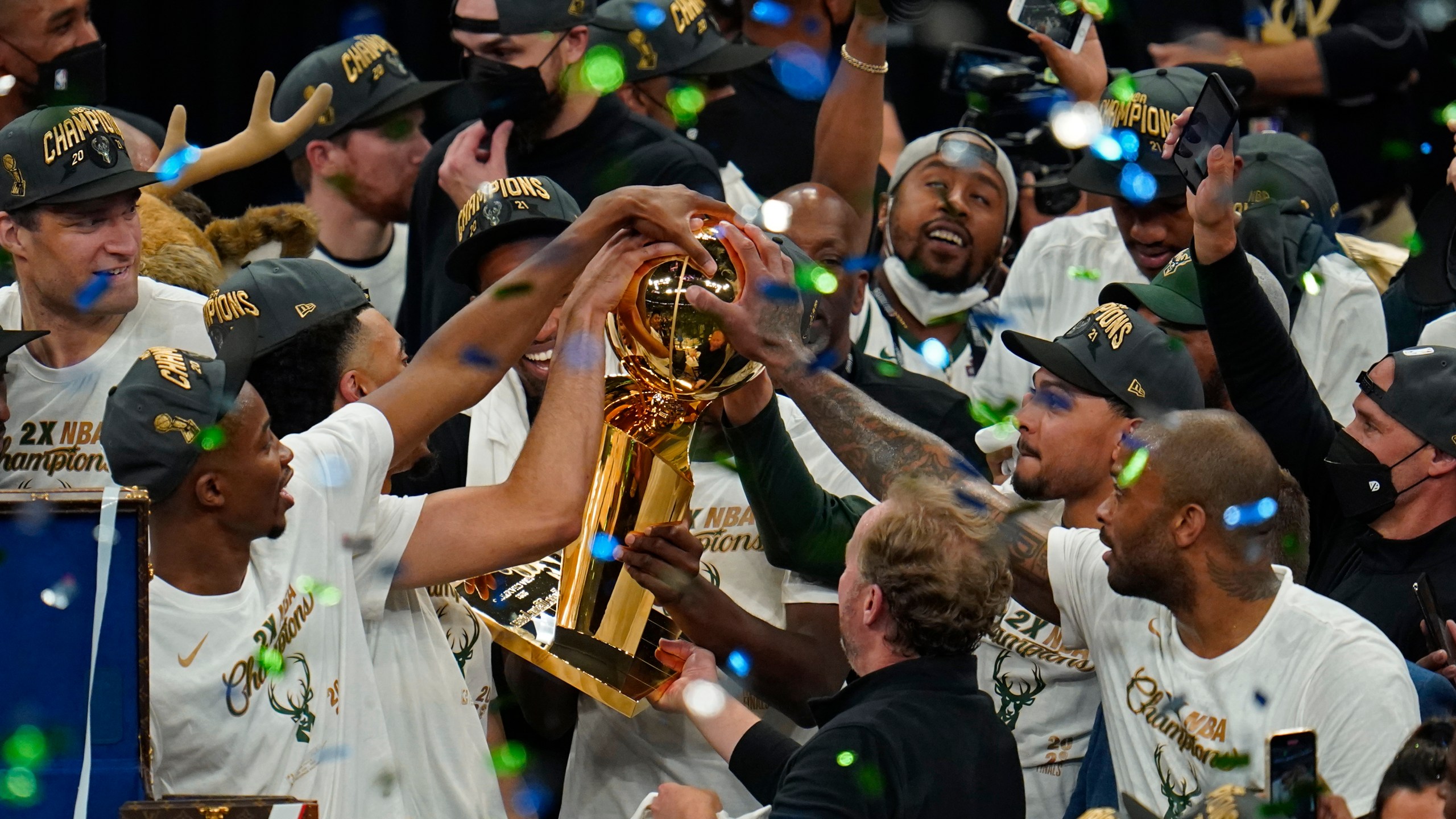 The Milwaukee Bucks celebrate with the championship trophy after defeating the Phoenix Suns in Game 6 of basketball's NBA Finals in Milwaukee on July 20, 2021. The Bucks won 105-98. (AP Photo/Paul Sancya)