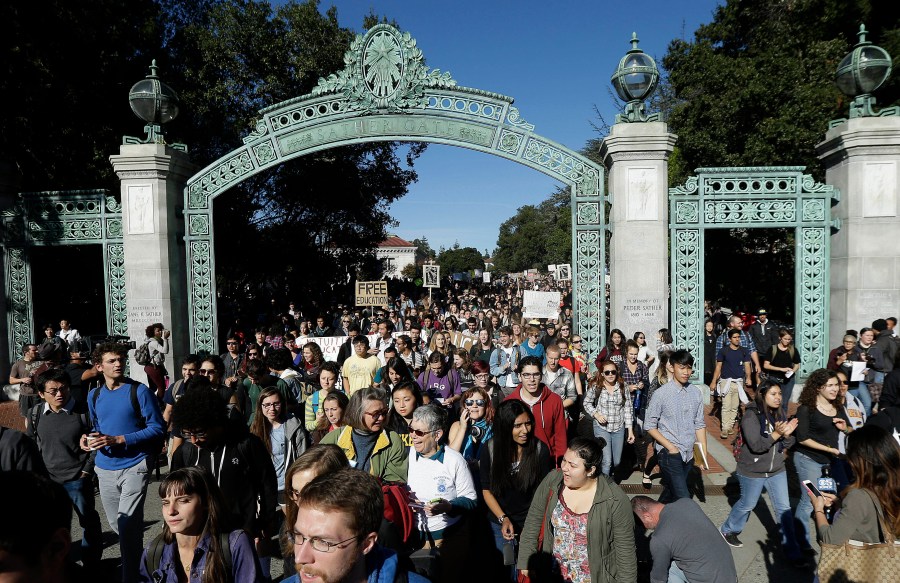 Students march under Sather Gate during a tuition-hike protest at the UC Berkeley on Nov. 24, 2014. (Jeff Chiu / Associated Press)