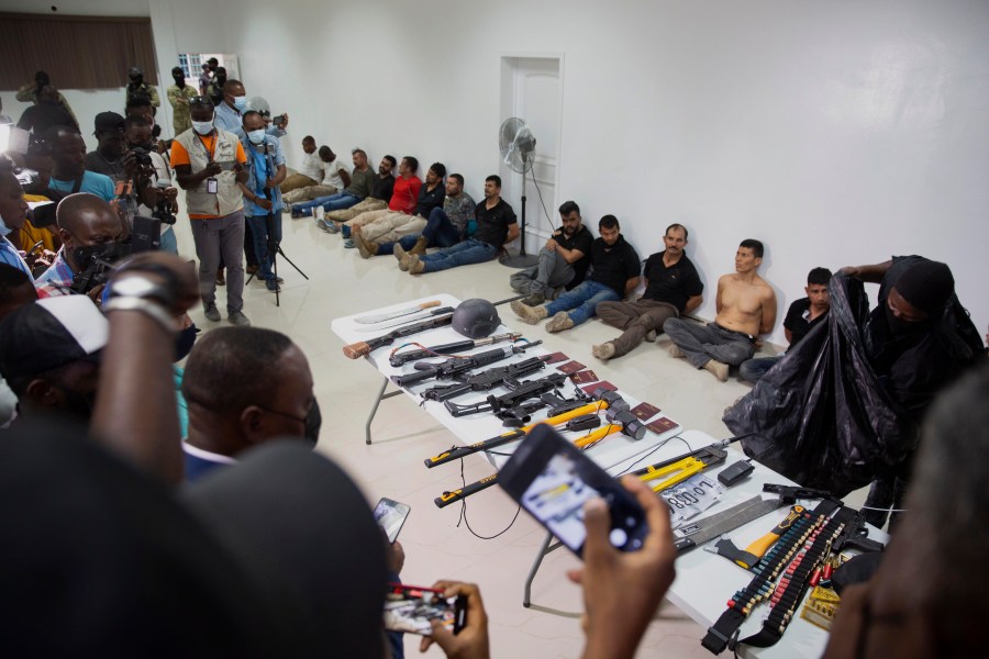 In this July 8, 2021 file photo, suspects in the assassination of Haiti's President Jovenel Moise are shown to the media, along with the weapons and equipment they allegedly used in the attack, at police headquarters in Port-au-Prince. (Jean Marc Hervé Abélard/Associated Press)