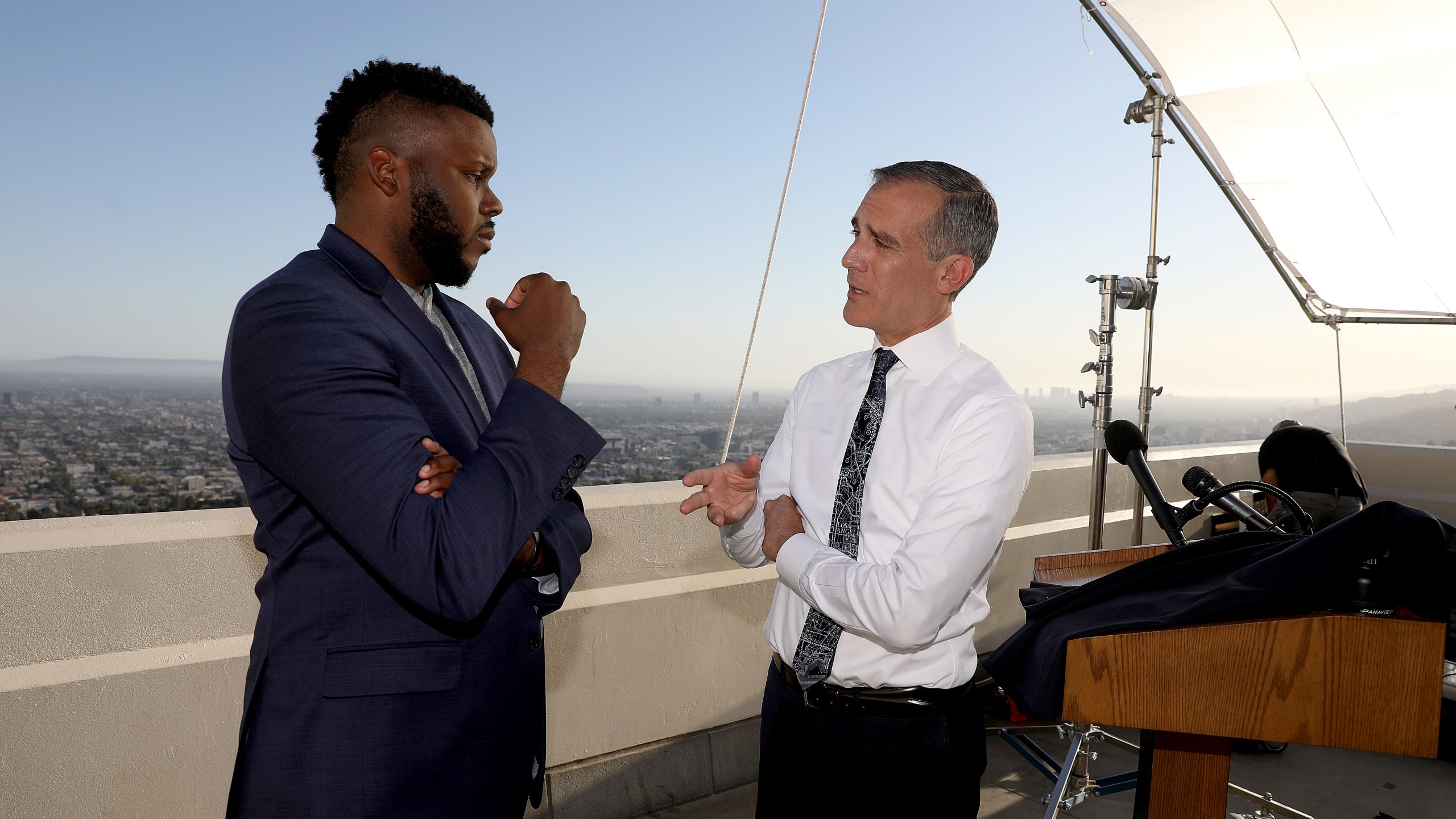 FILE - In this April 19, 2021 file photo, Los Angeles Mayor Eric Garcetti, right, talks with Michael Tubbs, founder of Mayors for a Guaranteed Income, after holding his annual State of the City address from the Griffith Observatory, in Los Angeles. (Gary Coronado/Los Angeles Times via AP, Pool File)