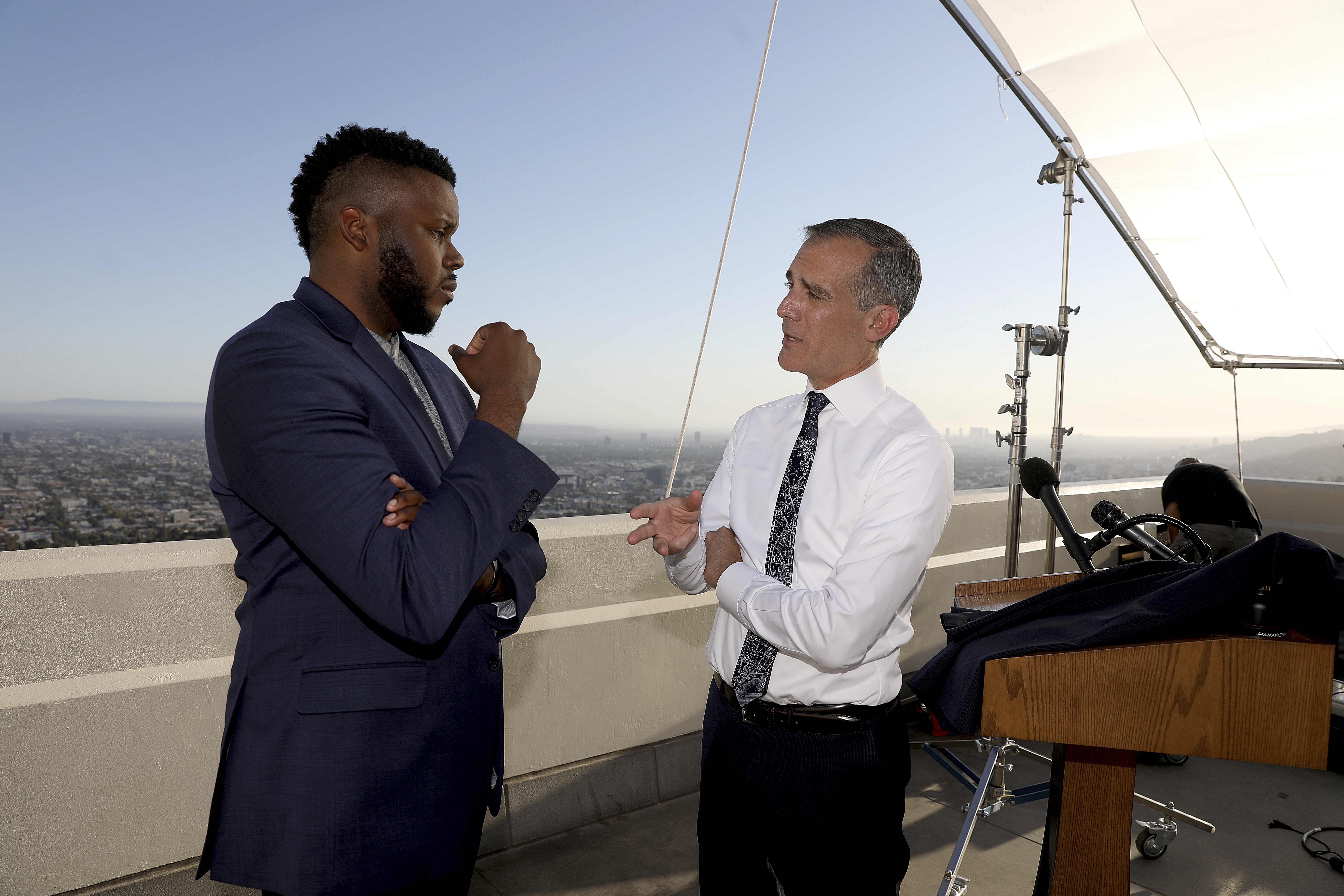 FILE - In this April 19, 2021 file photo, Los Angeles Mayor Eric Garcetti, right, talks with Michael Tubbs, founder of Mayors for a Guaranteed Income, after holding his annual State of the City address from the Griffith Observatory, in Los Angeles. (Gary Coronado/Los Angeles Times via AP, Pool File)