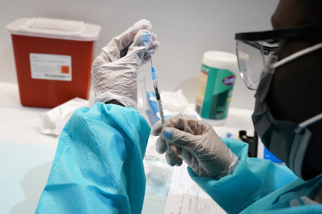 In this July 22, 2021, file photo, a health care worker fills a syringe with the Pfizer COVID-19 vaccine at the American Museum of Natural History in New York. (AP Photo/Mary Altaffer, File)