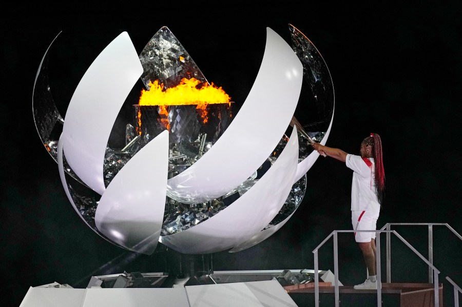 Naomi Osaka lights the Olympic flame during the opening ceremony in the Olympic Stadium at the 2020 Summer Olympics on July 23, 2021, in Tokyo. (David J. Phillip/Associated Press)