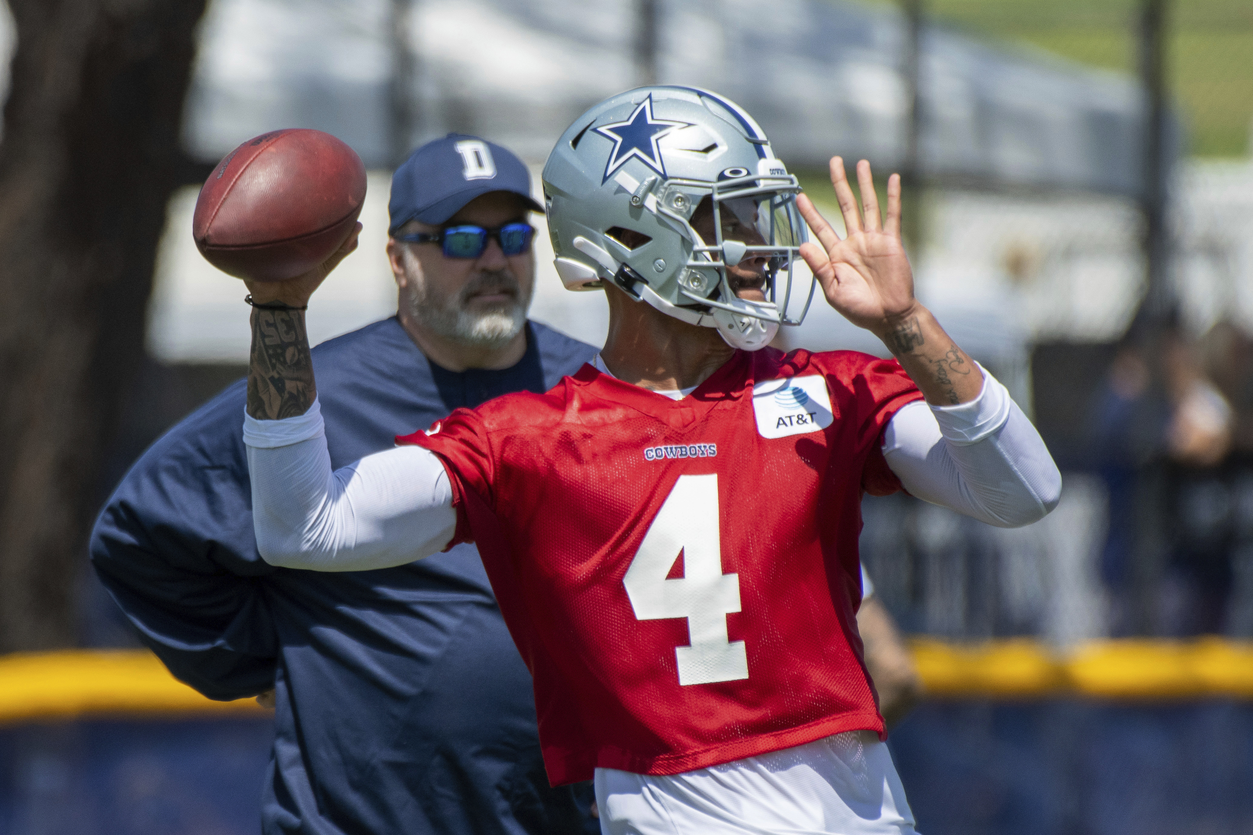 Dallas Cowboys quarterback Dak Prescott throws a pass as coach Mike McCarthy watches during the NFL football team's training camp in Oxnard, Calif., in this Thursday, July 22, 2021, file photo. (AP Photo/Michael Owen Baker, File)