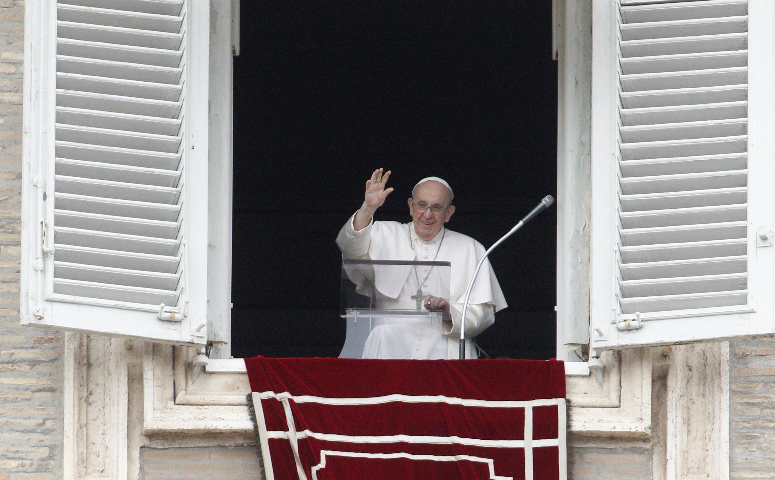 Pope Francis waves from his studio's window overlooking St. Peter's Square to celebrate the Angelus prayer, at the Vatican, Sunday, July 25, 2021. (AP Photo/Riccardo De Luca)