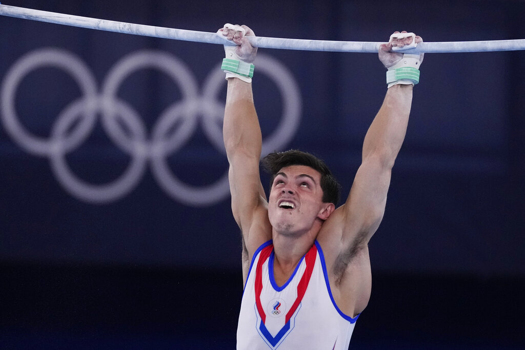 Artur Dalaloyan, of the Russian Olympic Committee, performs on the horizontal bar during the artistic men's team final at the 2020 Summer Olympics, Monday, July 26, 2021, in Tokyo. (AP Photo/Ashley Landis)