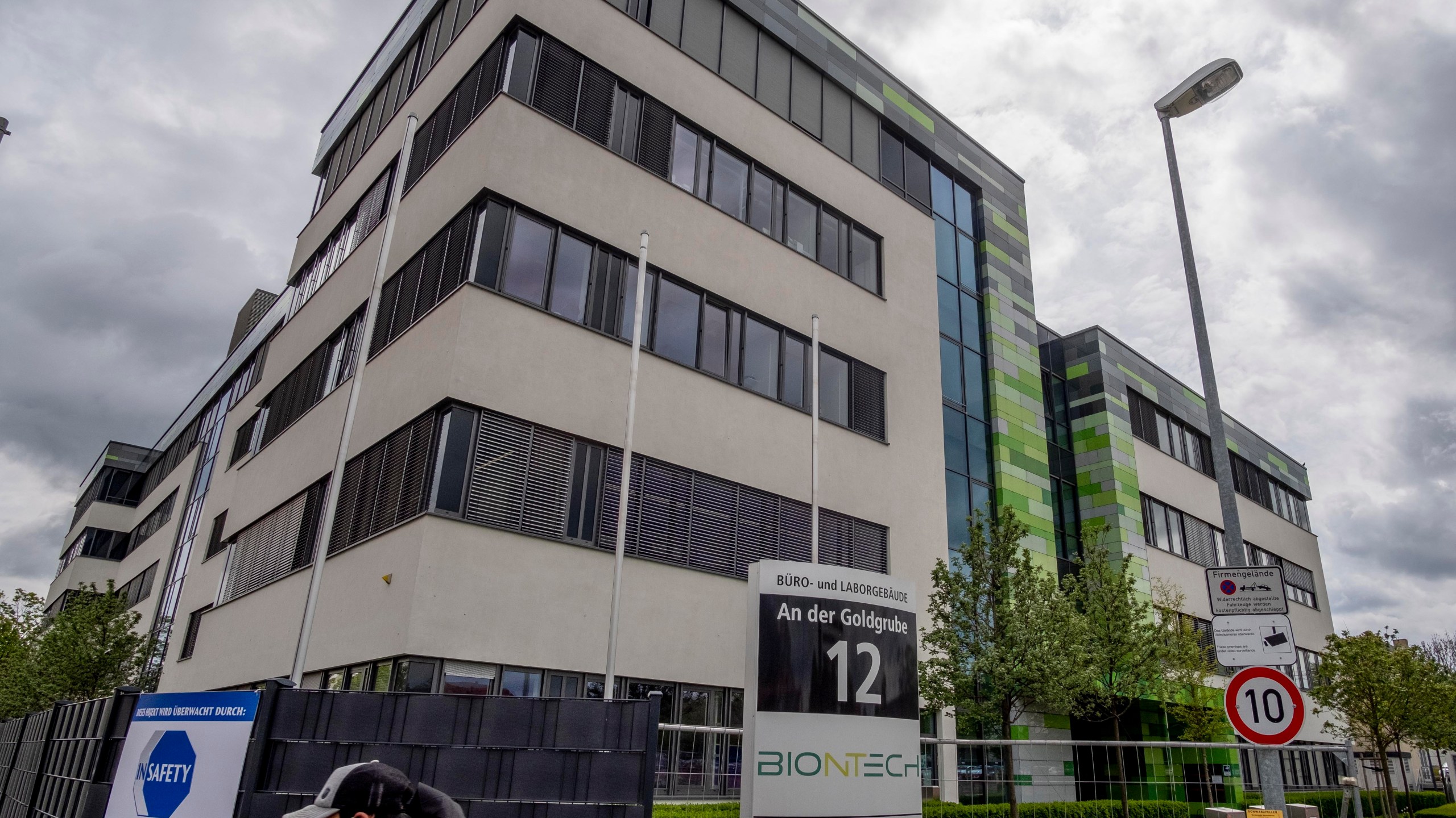 In this May 6, 2021 file photo a man with a face mask leaves the headquarters of the German biotechnology company "BioNTech" in Mainz, Germany. (AP Photo/Michael Probst, file)