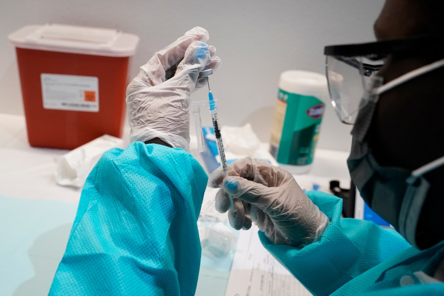 A health care worker fills a syringe with the Pfizer COVID-19 vaccine, Thursday, July 22, 2021, at the American Museum of Natural History in New York. (AP Photo/Mary Altaffer, File)