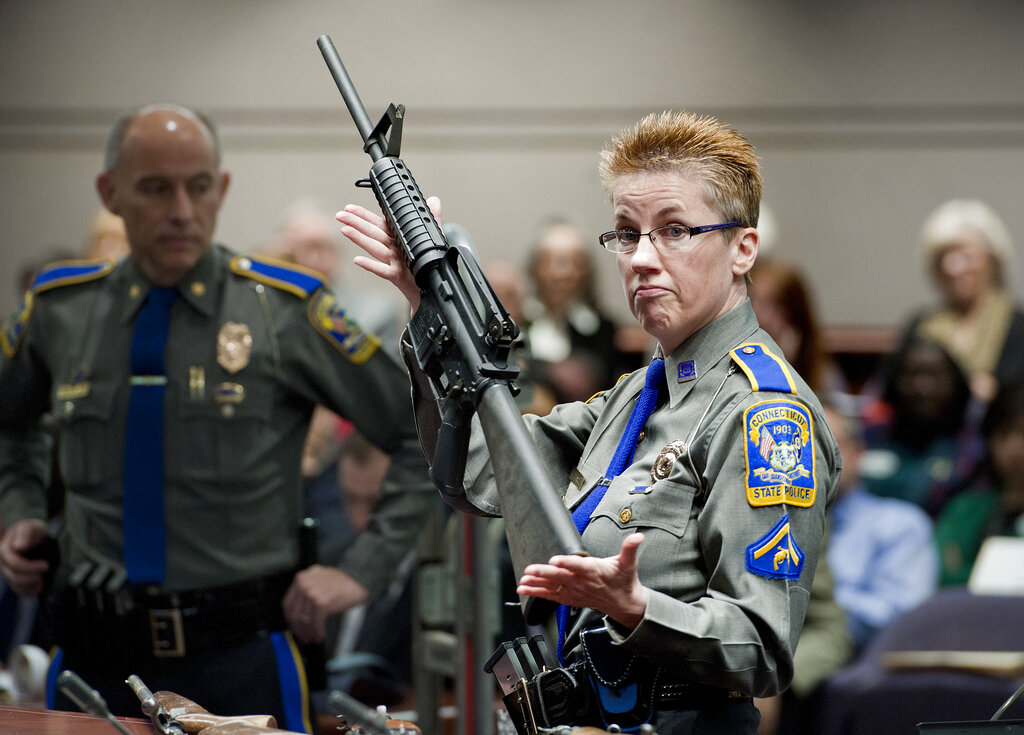 In this Jan. 28, 2013, file photo, firearms training unit Detective Barbara J. Mattson, of the Connecticut State Police, holds up a Bushmaster AR-15 rifle. (AP Photo/Jessica Hill, File)