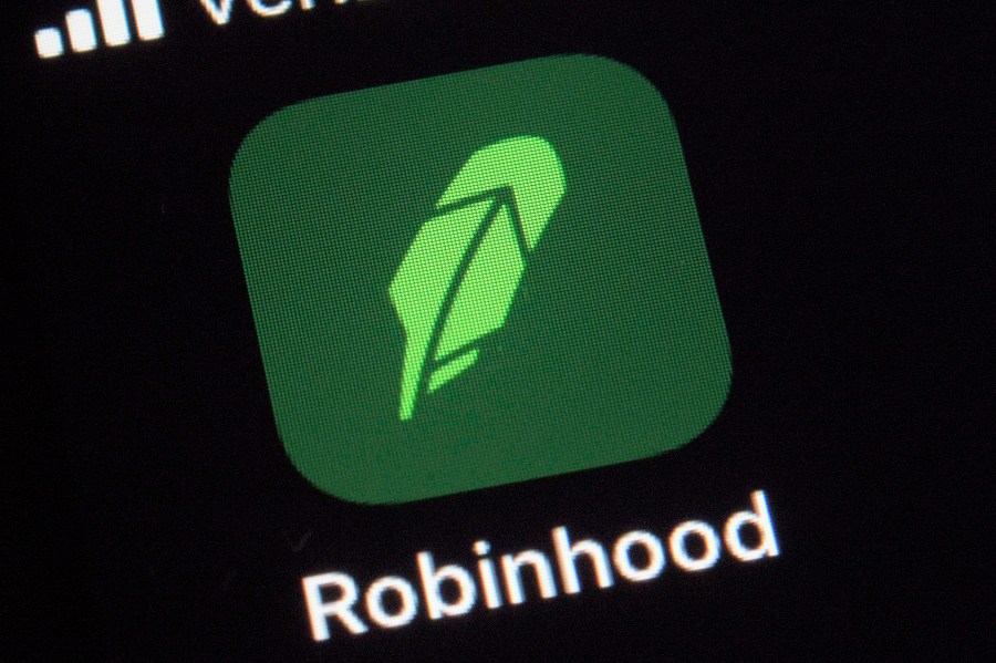 This Dec. 17, 2020, photo shows the logo for the Robinhood app on a smartphone in New York. After a rocket rise where it introduced millions of people to investing and reshaped the brokerage industry, all while racking up a long list of controversies in less than eight years, Robinhood is about to take the leap itself into the stock market. Robinhood Markets and three of its executives are selling up to 60.5 million shares of its stock in an initial public offering, with trading expected to begin on the Nasdaq Thursday, July 29, 2021. (AP Photo/Patrick Sison, File)