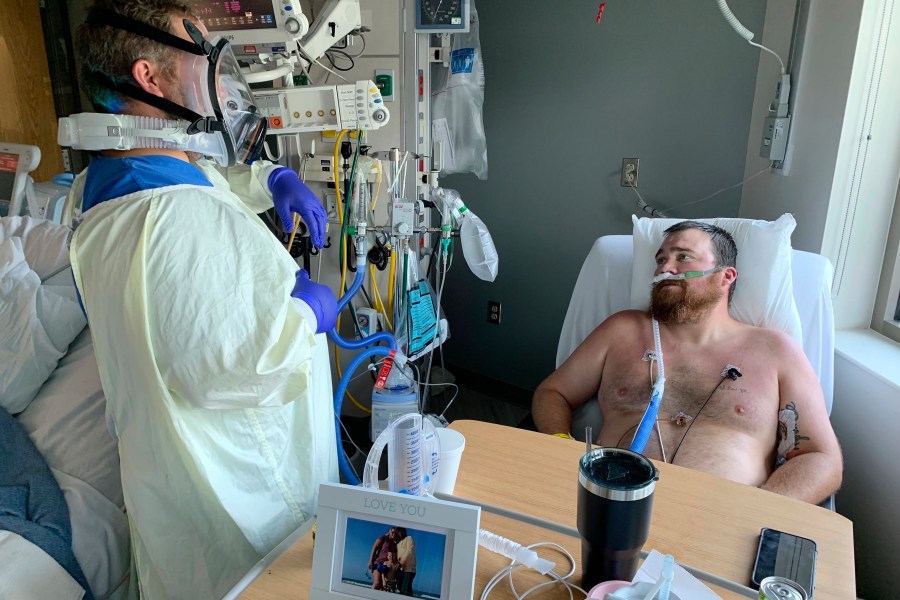 Registered Nurse Chris Murphy walks 31-year-old Daryl Barker through breathing techniques inside Lake Regional Hospital's Intensive Care Unit on Monday, July 26, 2021, in Osage Beach, Mo. Murphy, an Army veteran who served as a Combat Medic in Iraq often leans on the resiliency he learned in the military to fight off mental fatigue. (AP Photo/Sarah Blake Morgan)