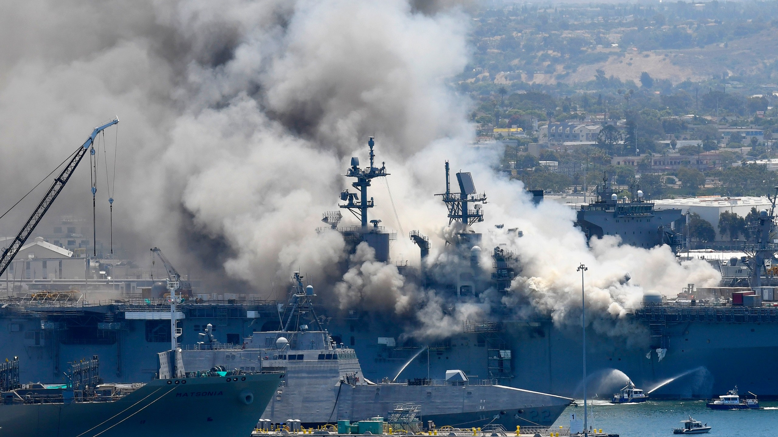 In this July 12, 2020, file photo, smoke rises from the USS Bonhomme Richard in San Diego after an explosion and fire on board the ship at Naval Base San Diego. (Denis Poroy/Associated Press)