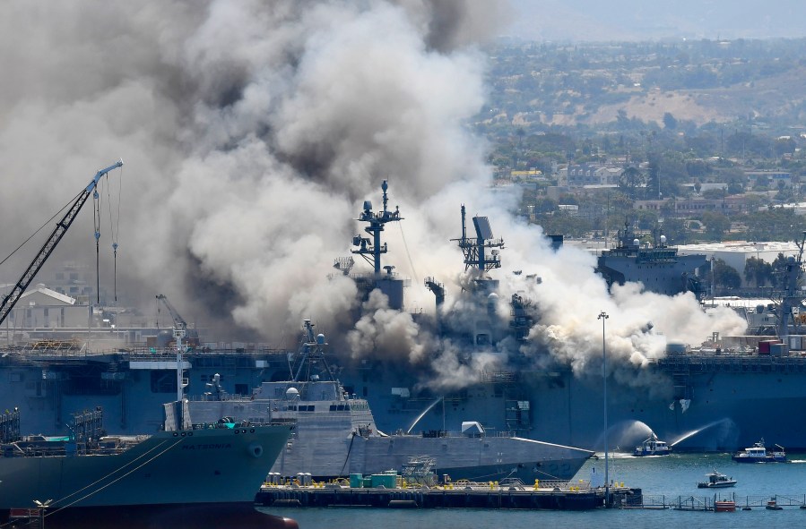 In this July 12, 2020, file photo, smoke rises from the USS Bonhomme Richard in San Diego after an explosion and fire on board the ship at Naval Base San Diego. (Denis Poroy/Associated Press)