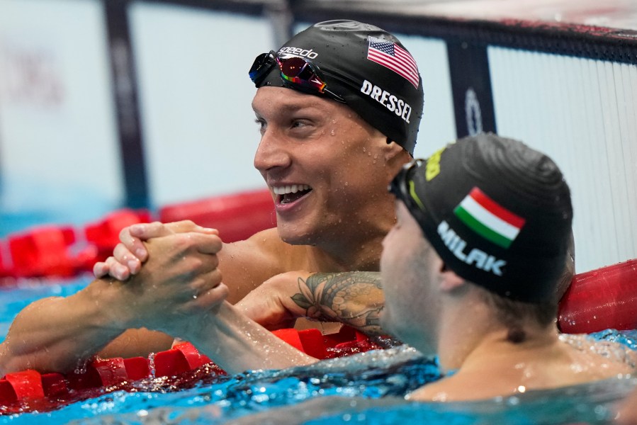 Caeleb Dressel, of United States, celebrates after wining the gold medal in the men's 100-meter butterfly final at the 2020 Summer Olympics, on July 31, 2021, in Tokyo, Japan. (AP Photo/David Goldman)