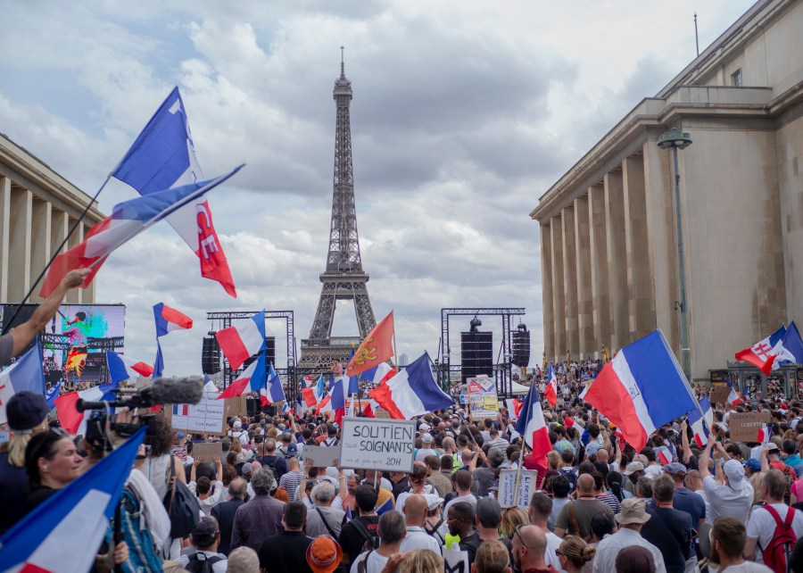 Thousands of protesters gather at Place Trocadero near the Eiffel Tower attend a demonstration in Paris, France, July 24, 2021, against the COVID-19 pass which grants vaccinated individuals greater ease of access to venues. (AP Photo/Rafael Yaghobzadeh)