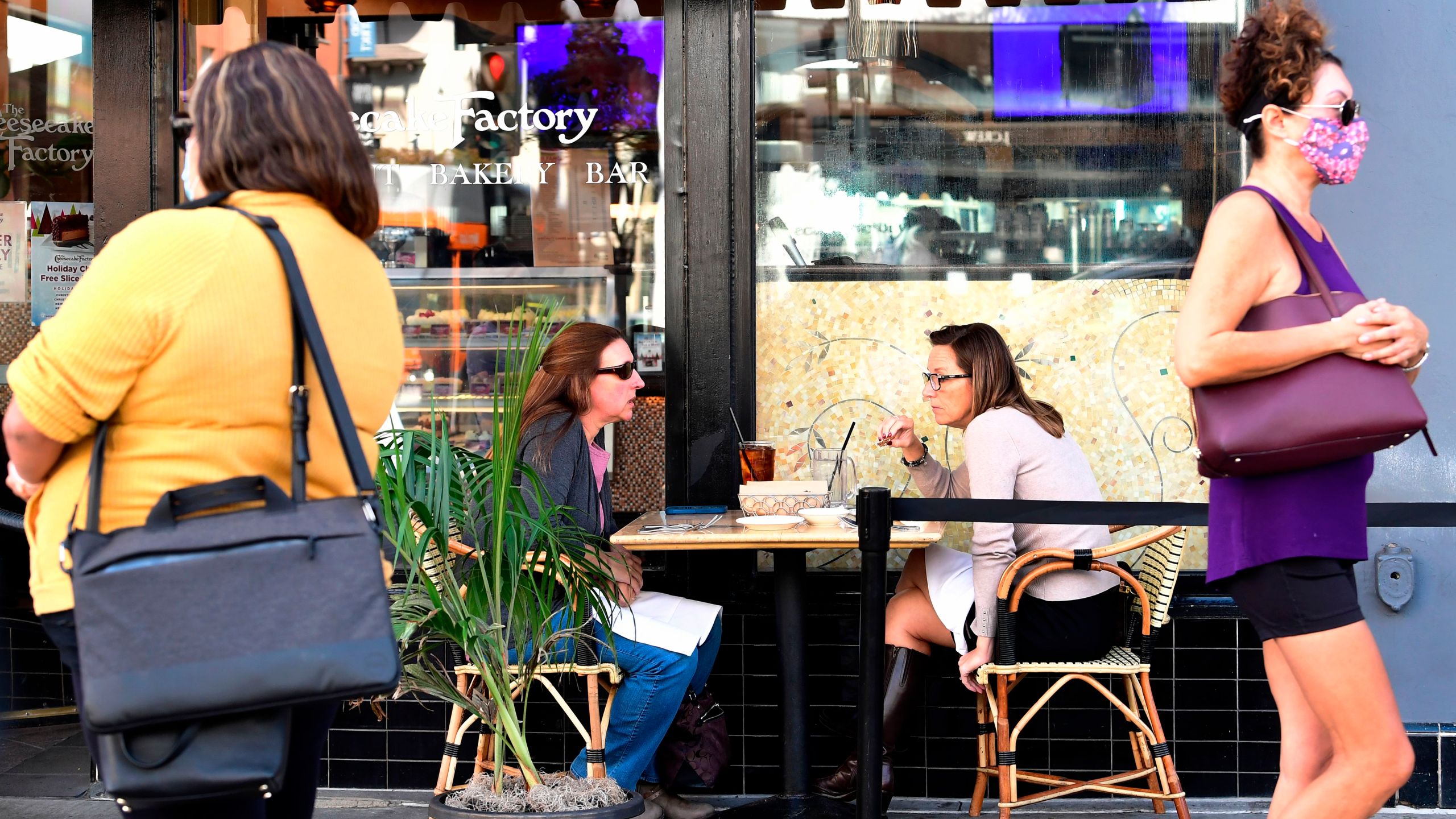 People dine outdoors in Pasadena, California, the only city in Los Angeles County still allowing that service on December 2, 2020. (FREDERIC J. BROWN/AFP via Getty Images)