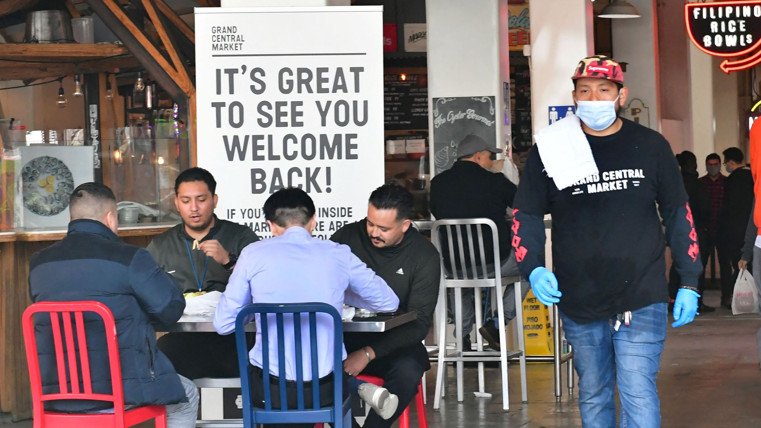 People enjoy lunch at Grand Central Market as indoor dining reopens in Los Angeles, on March 15, 2021. (Frederic J. Brown/AFP via Getty Images)