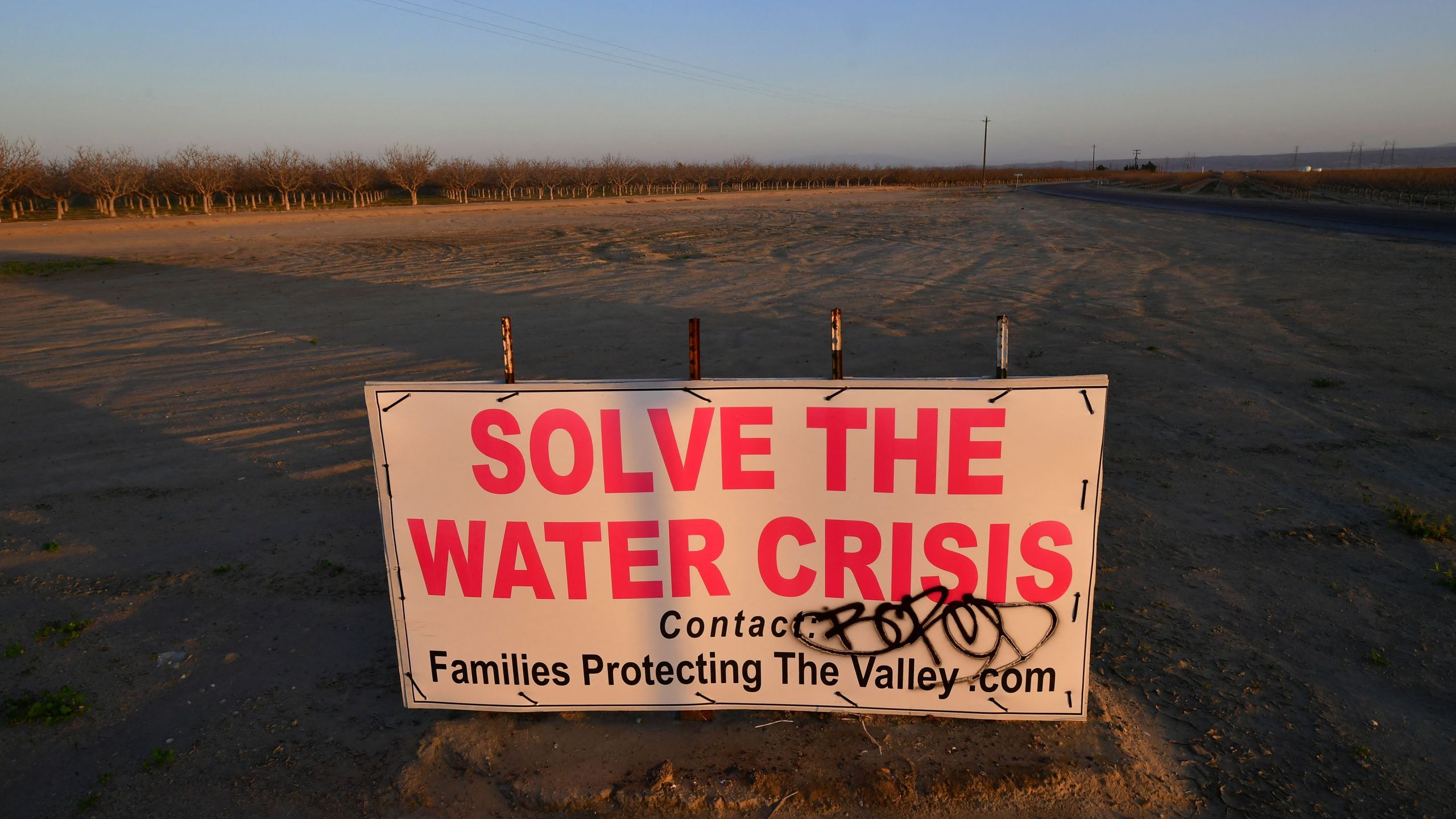 A sign calls for solving California's water crisis on the outskirts of Buttonwillow in California's Kern County on April 2, 2021, one of the top agriculture producing counties in the San Joaquin Valley where dairy, grapes, almonds, strawberries, and pistachios contribute billions to the economy each year. (FREDERIC J. BROWN/AFP via Getty Images)