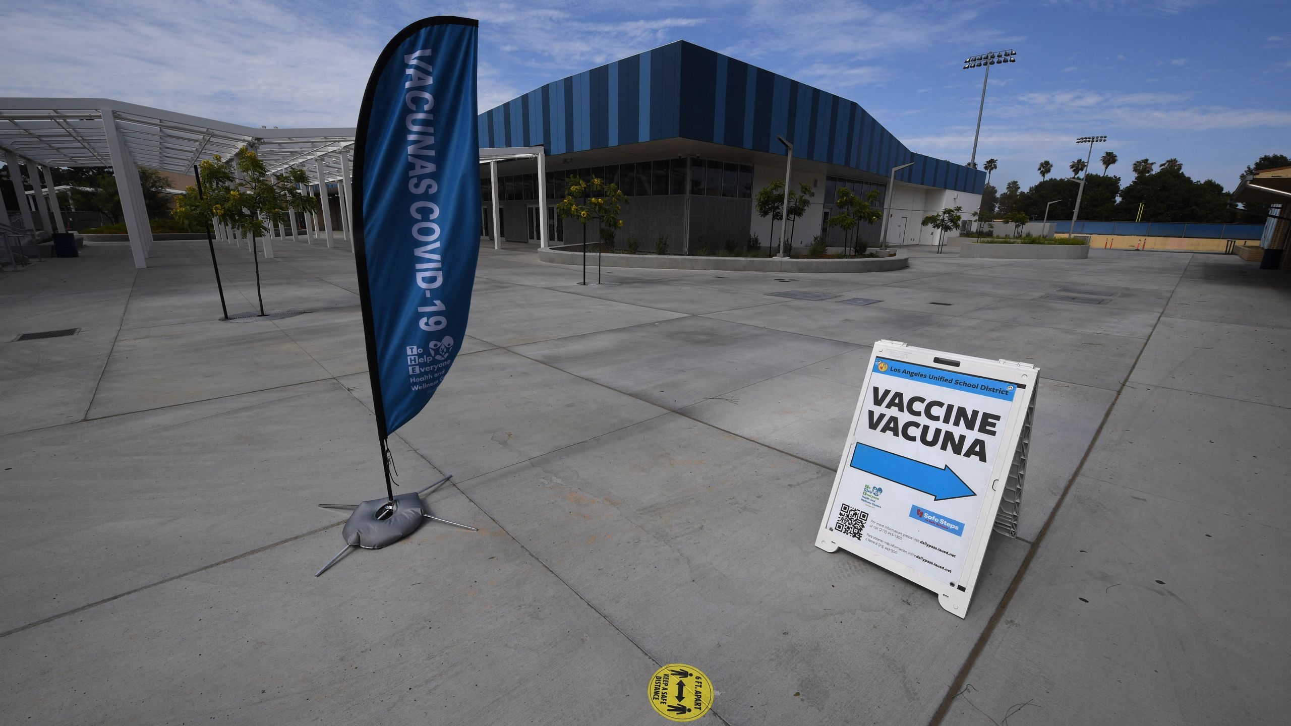 A sign points to a Covid-19 vaccination clinic offering the Pfizer vaccine to anyone over the age of 12 who wants it at Crenshaw High School in South Los Angeles, on July 8, 2021. The clinic was empty except for the staff working there. (ROBYN BECK/AFP via Getty Images)