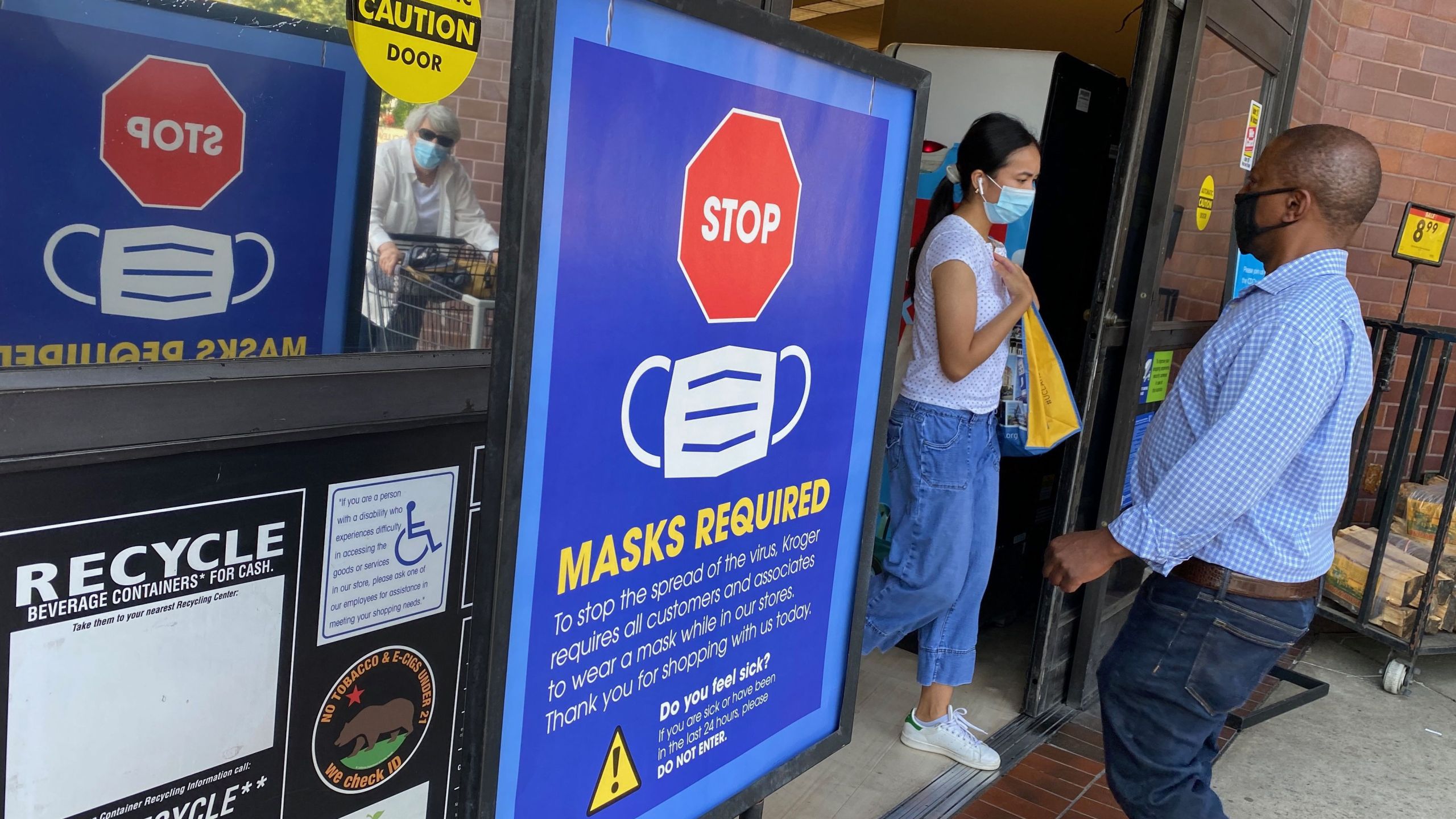 People shop at a grocery store enforcing the wearing of masks in Los Angeles on July 23, 2021. (Chris Delmas / AFP / Getty Images)