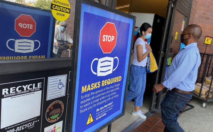 People shop at a grocery store enforcing the wearing of masks in Los Angeles on July 23, 2021. (Chris Delmas / AFP / Getty Images)