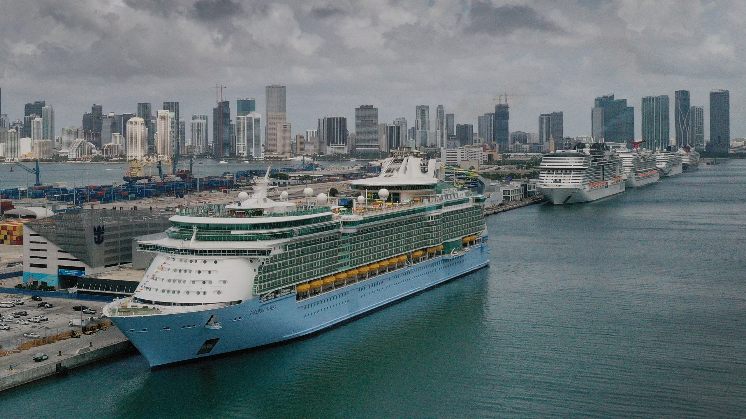 In an aerial view, the Royal Caribbean Freedom of the Seas (L) prepares to set sail from PortMiami during the first U.S. trial cruise testing COVID-19 protocols on June 20, 2021 in Miami, Florida. (Joe Raedle/Getty Images)