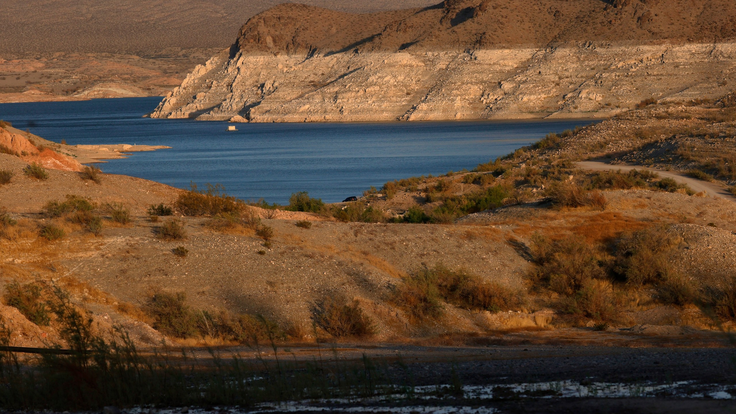 Mineral-stained rocks are shown at Echo Bay on June 21, 2021 in the Lake Mead National Recreation Area, Nevada. The lake has seen declining water levels as a result of a nearly continuous drought over two decades and increased water demand in the Southwest. The drought has left a white "bathtub ring" of mineral deposits left by higher water levels on the rocks around the lake. ( Ethan Miller/Getty Images)