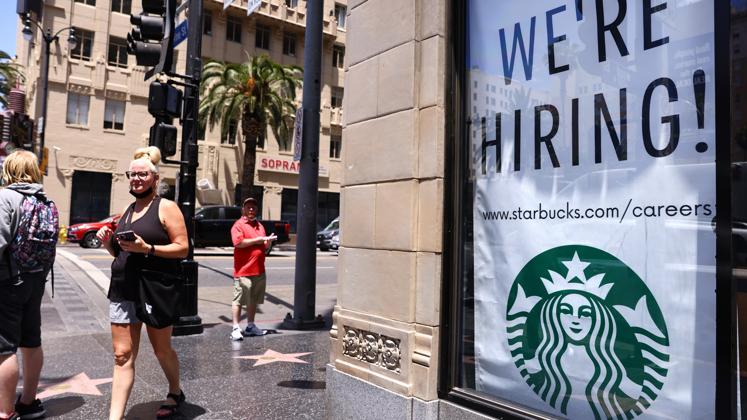 A 'We're Hiring!' sign is displayed at a Starbucks on Hollywood Boulevard on June 23, 2021 in Los Angeles. (Mario Tama/Getty Images)