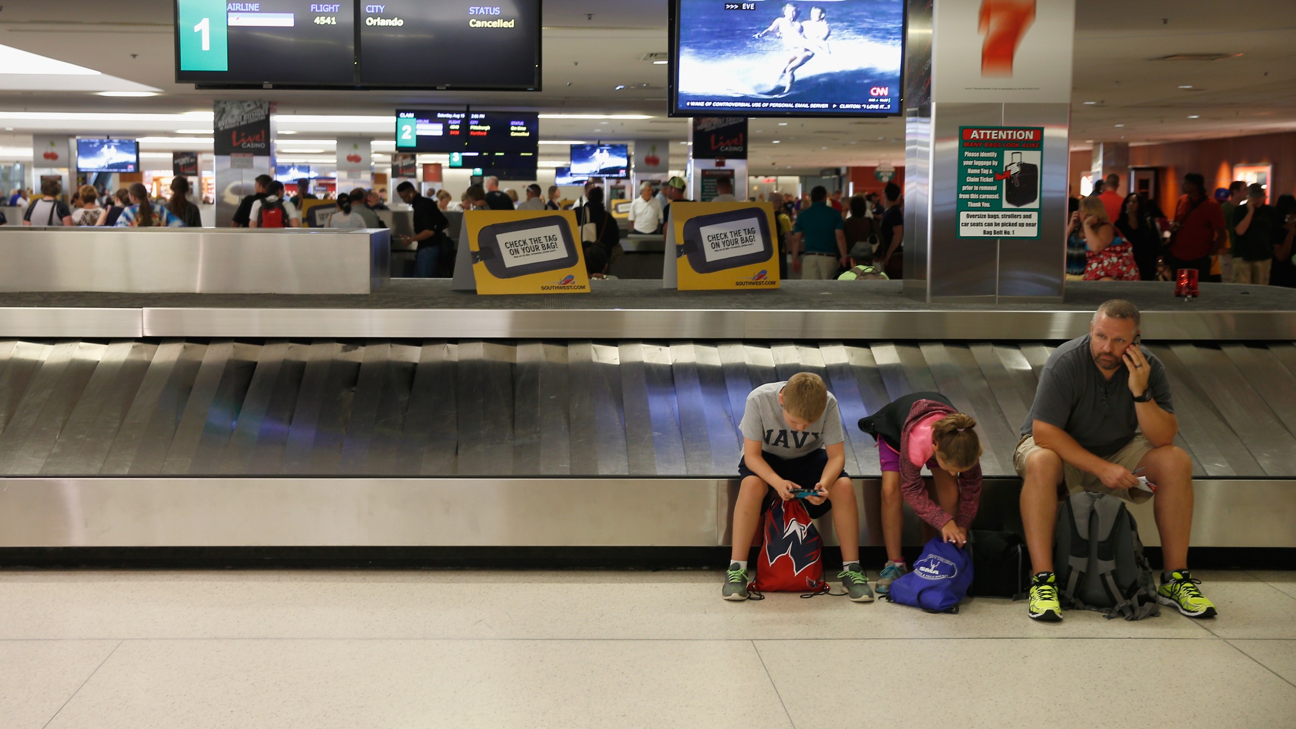 Passengers wait for bags at baggage claim in Baltimore/Washington International Thurgood Marshall Airport in Maryland in this Aug. 15, 2015 file photo. (Rob Carr/Getty Images)