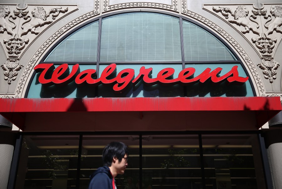 This file photo shows a pedestrian walking by a Walgreens store in San Francisco on April 5, 2016. (Justin Sullivan/Getty Images)