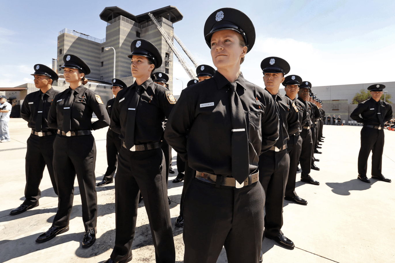 Katie Becker, center, at her April 2016 graduation ceremony from the Los Angeles Fire Department’s Valley Recruit Training Academy. Becker has since left the department.(Al Seib / Los Angeles Times)