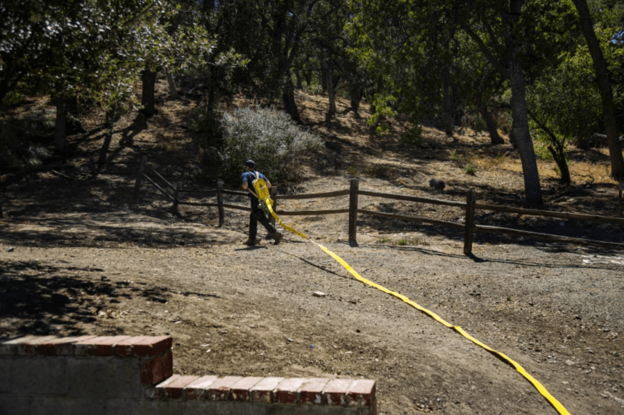 U.S. Forest Service firefighter Nick Browne deploys a fire hose pack during training in Castaic. Crews in the bone-dry forest must aim for 100% mop-up, meaning they must extinguish every ember. “There are no shortcuts here,” he said.(Gina Ferazzi / Los Angeles Times)