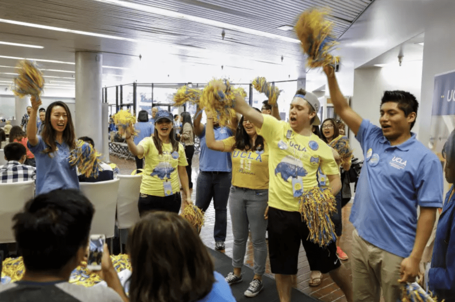 Students and staff cheer on a student after he completes his intent to enroll at UCLA in this undated file photo. (Jay L. Clendenin / Los Angeles Times)