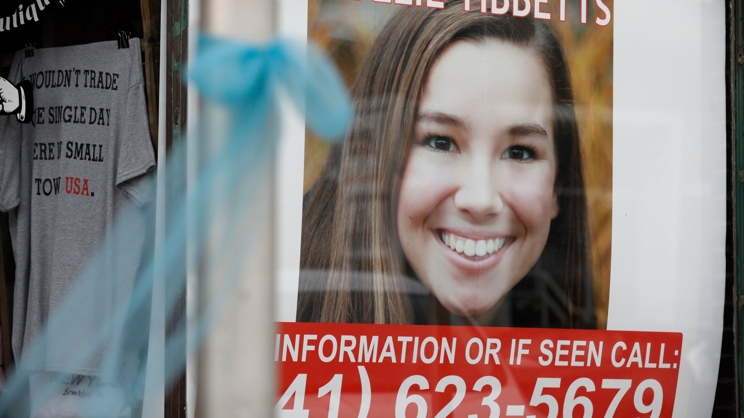 In this Aug. 21, 2018, photo, a poster for missing University of Iowa student Mollie Tibbetts hangs in the window of a local business in Brooklyn, Iowa. (AP Photo/Charlie Neibergall)